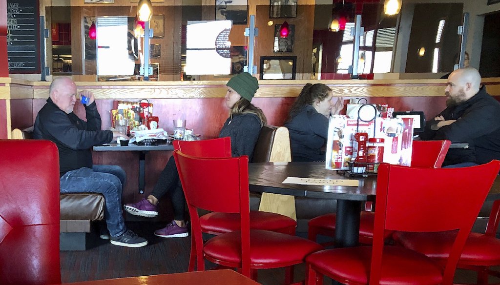 A Red Robin restaurant in Tigard, Ore., has closed some tables in order to maintain "social distancing" between diners per CDC guidelines March 15. They said they were running the place at 50% capacity so they could leave tables empty. (AP)