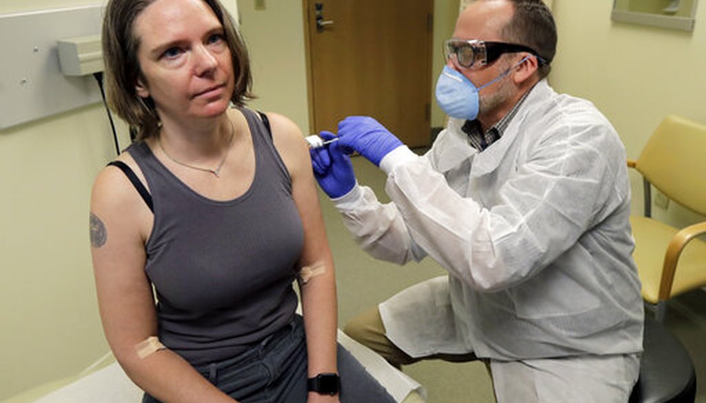 A pharmacist gives Jennifer Haller, left, the first shot in the clinical trial of a potential vaccine for COVID-19 on March 16, 2020, in Seattle. (AP)
