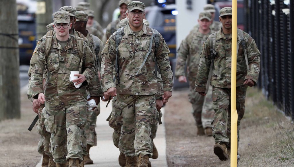 National Guard personnel march in formation as they leave duty after working on March 19, 2020, at a state-managed coronavirus drive-through testing site that just opened on Staten Island in New York. (AP)