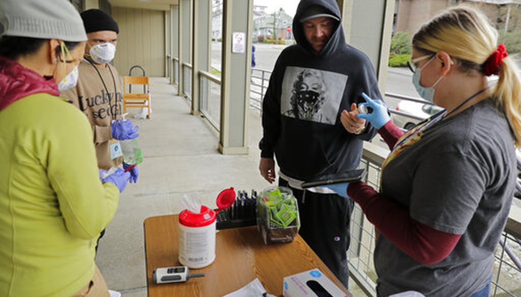 A patient picks up medication for opioid addiction at a clinic in Olympia, Wash., on March 27, 2020. The clinic is meeting patients outdoors and offering longer prescriptions during the coronavirus pandemic. (AP)