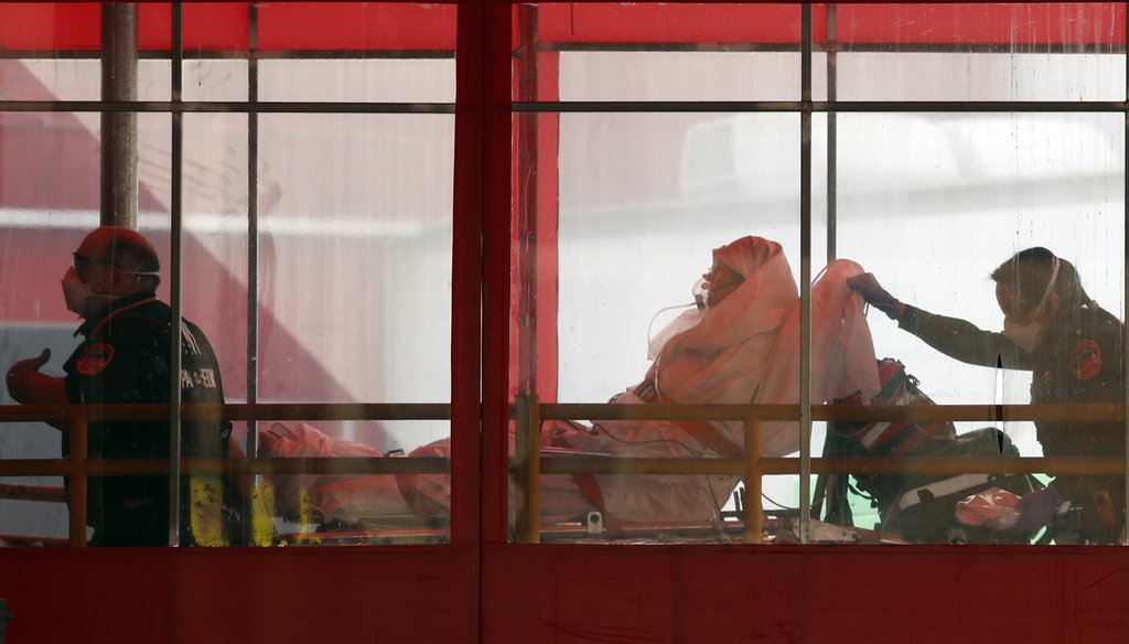 Emergency medical technicians wheel a patient into Elmhurst Hospital Center's emergency room on April 7, 2020, in the Queens borough in New York, during the current coronavirus outbreak. (AP)