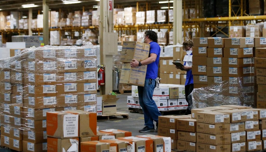 Workers carry boxes at Oklahoma's Strategic National Stockpile warehouse in Oklahoma City, Tuesday, April 7, 2020. (AP)