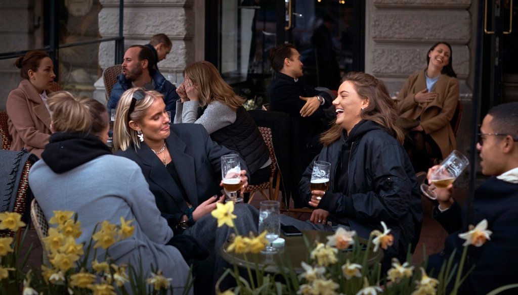 In this Wednesday, April 8, 2020 file photo people chat and drink outside a bar in Stockholm, Sweden. Sweden is pursuing relatively liberal policies to fight the coronavirus pandemic, even though there has been a sharp spike in deaths. (AP)
