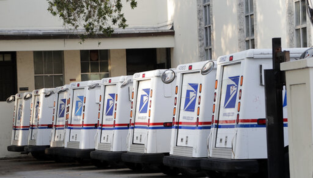 U.S. Postal Service trucks are lined up on April 13, 2020, in Miami Beach, Florida. (AP/Sladky)
