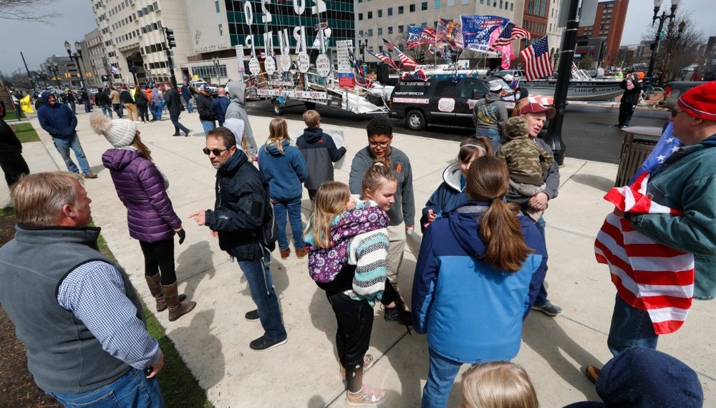 People stand near the Michigan State Capitol to view a protest in Lansing, Mich., on April 15, 2020, over a stay-at-home order issued by Gov. Gretchen Whitmer in response to the coronavirus pandemic. (AP)