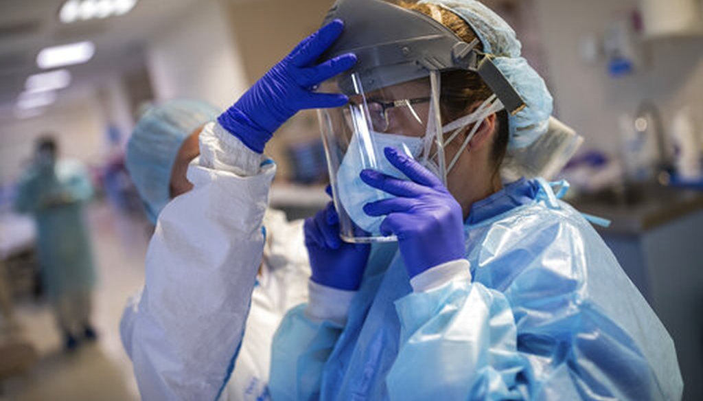 Healthcare workers put on protective gear to assist coronavirus patients at an intensive care unit in Madrid, Spain, on April 16, 2020. (AP)