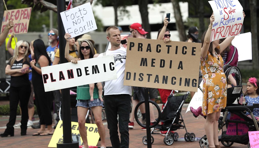 Protesters demanding Florida businesses and government reopen, march in downtown Orlando, Fla., on April 17, 2020. (AP)