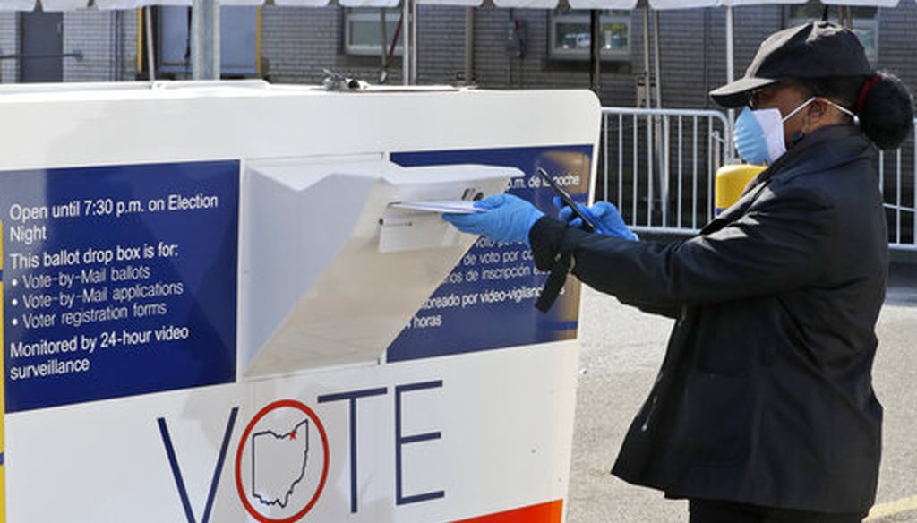 Marcia McCoy drops her ballot into a box outside the Cuyahoga County Board of Elections on April 28, 2020, in Cleveland, Ohio. (AP)