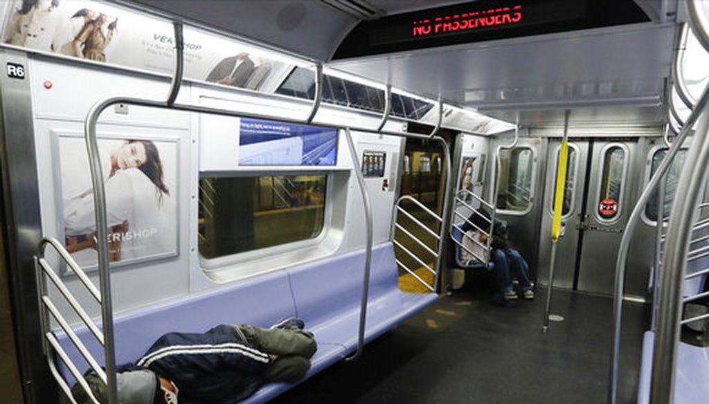 Homeless New Yorkers sleep on a train in Brooklyn on May 6, 2020. (AP)