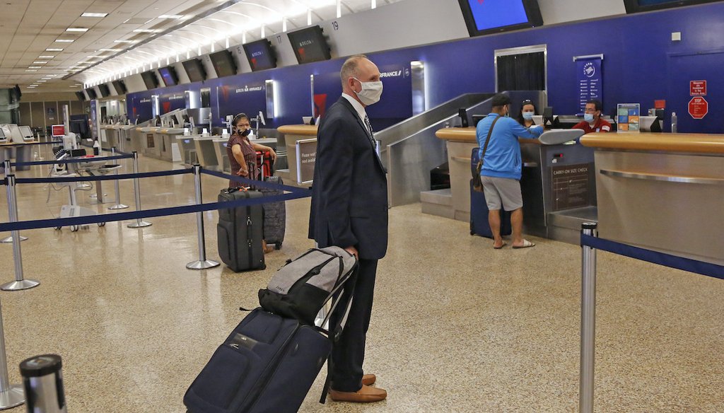 Passengers wait at a ticket counter at Salt Lake City International Airport on May 11, 2020. (AP)