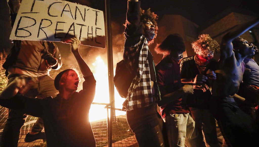 Protestors demonstrate outside of a burning Minneapolis 3rd Police Precinct on May 28, 2020, in Minneapolis. (AP)