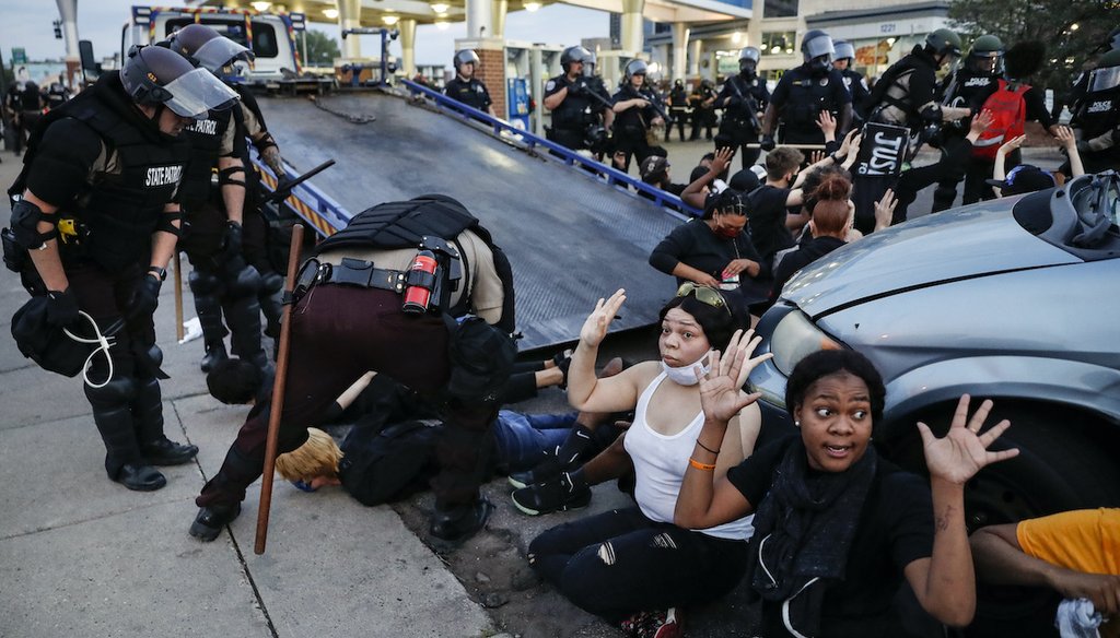 Protesters raise their hands on command from police as they are detained prior to arrest on May 31, 2020, in Minneapolis.  (AP)