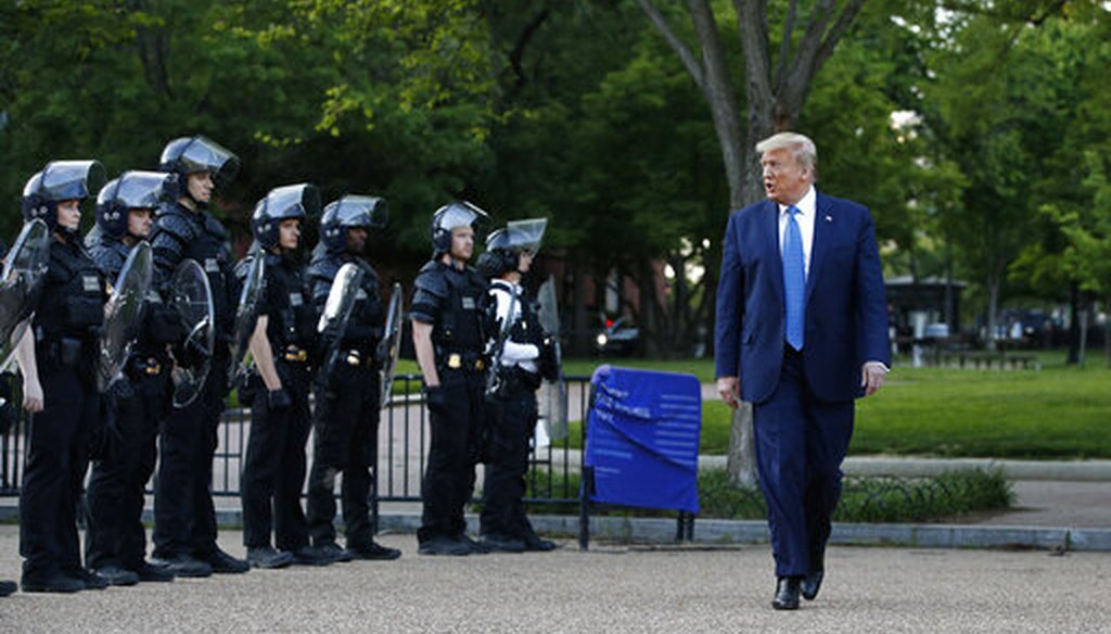President Donald Trump walks past police in Lafayette Park across from the White House on June 1, 2020. (AP)