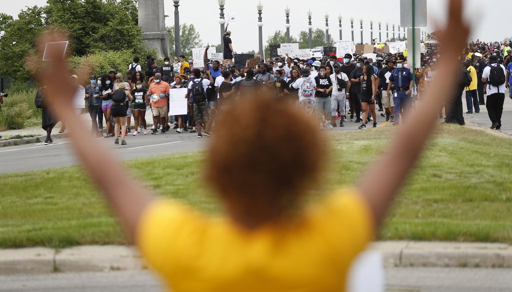 Protesters march on MacArthur Bridge across the Detroit River during a rally in Detroit, Friday, June 5, 2020, over the death of George Floyd, a black man who died after being restrained by Minneapolis police officers. (AP)