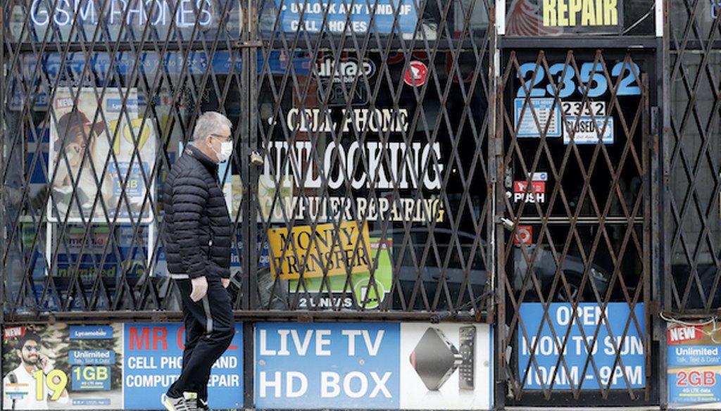 In a April 30, 2020 file photo, a man walks by a closed store during the COVID-19 pandemic in Chicago. (AP)