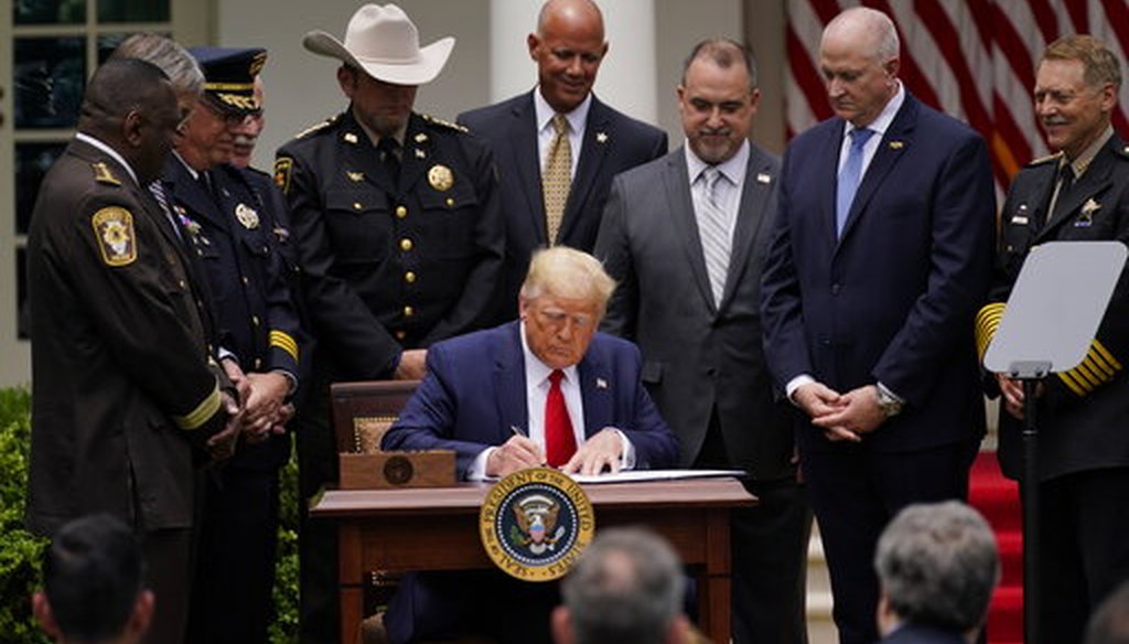 President Donald Trump signs an executive order on police reform, in the Rose Garden of the White House, June 16, 2020, in Washington. (AP/Evan Vucci)