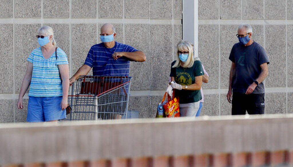Customers wear masks as they wait to enter a store in Tempe, Ariz., on June 17, 2020. The state was undergoing a major increase in new coronavirus cases. (AP)
