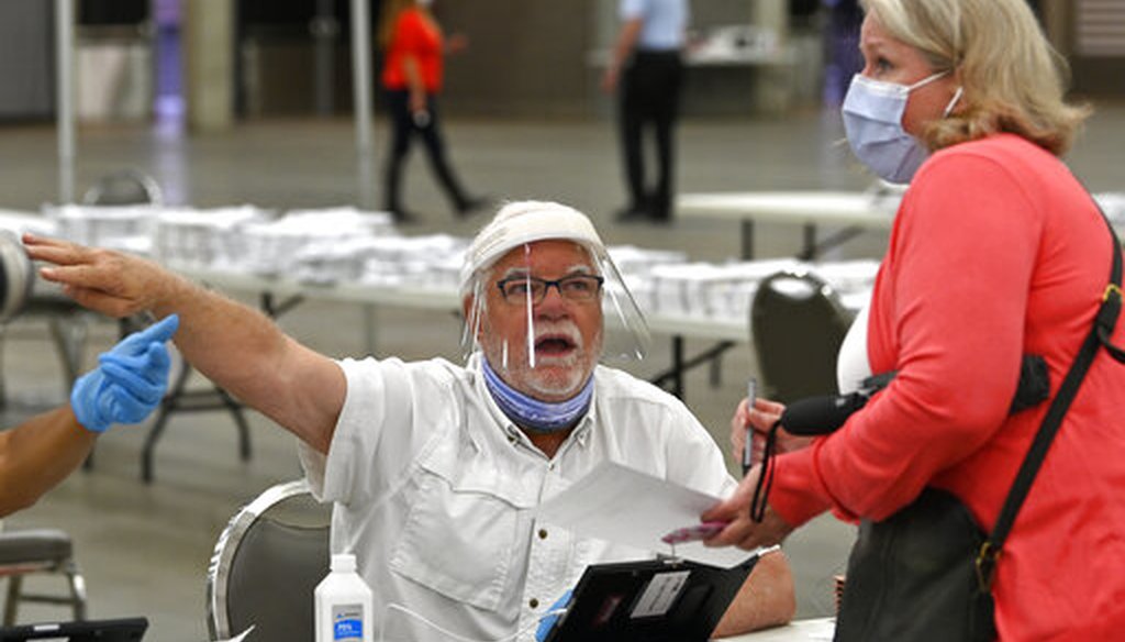 Poll workers instruct a voter on where to fill out their ballot during the Kentucky primary at the Kentucky Exposition Center in Louisville, Ky., on June 23, 2020. (AP)