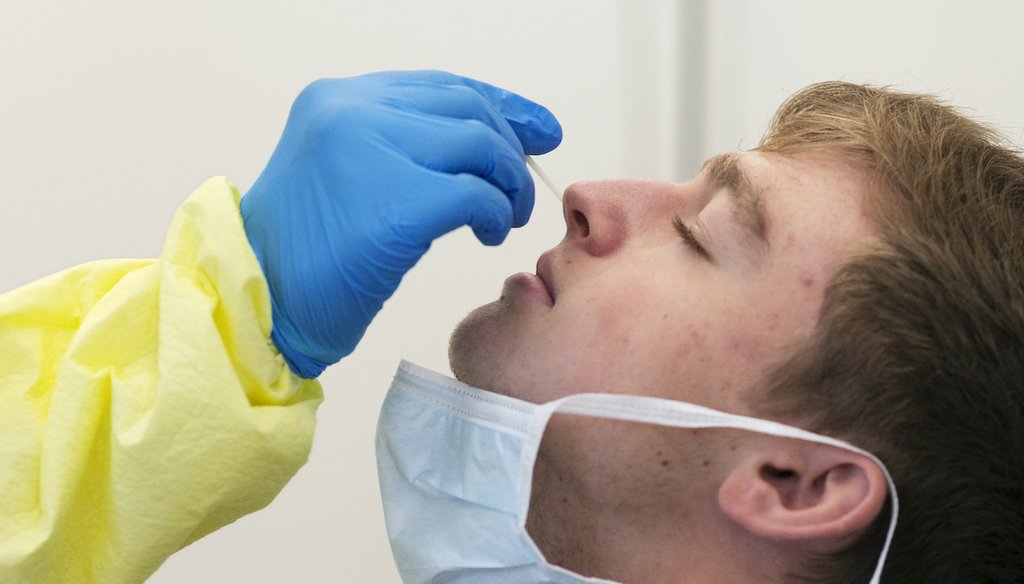 Eric Antosh has a nasal swab taken by a nurse at a COVID-19 testing site in Brooklyn, N.Y., run by NYC Health + Hospitals on July 8, 2020. (AP)