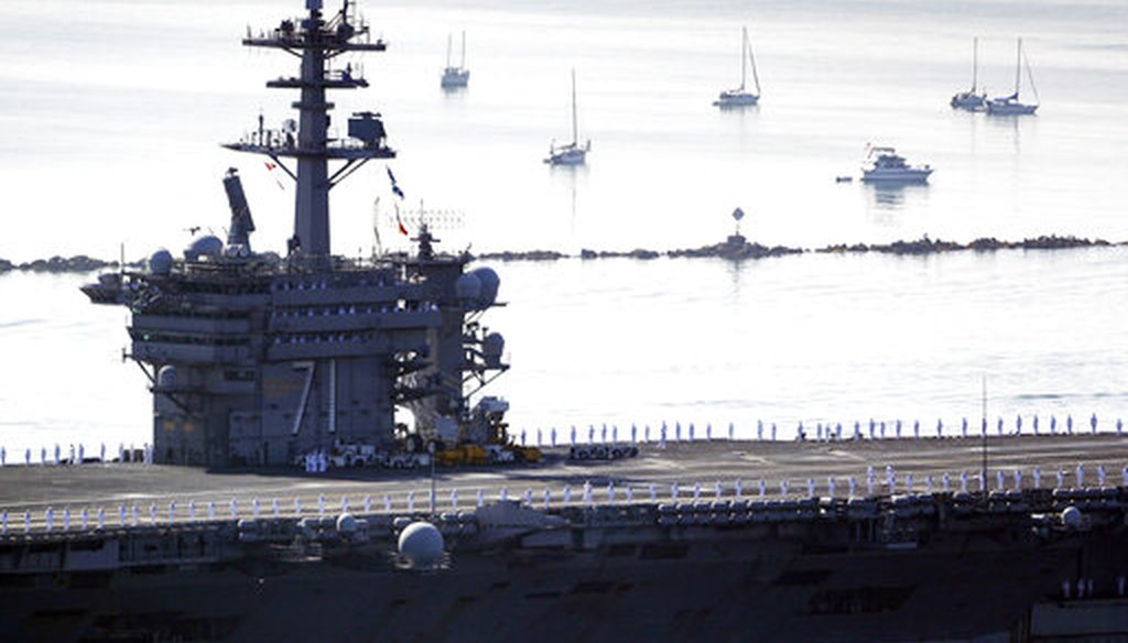 Sailors man the rails as the USS Theodore Roosevelt aircraft carrier makes its way into San Diego Bay on July 9, 2020. The carrier returned to San Diego after a massive COVID-19 outbreak on board. (AP)