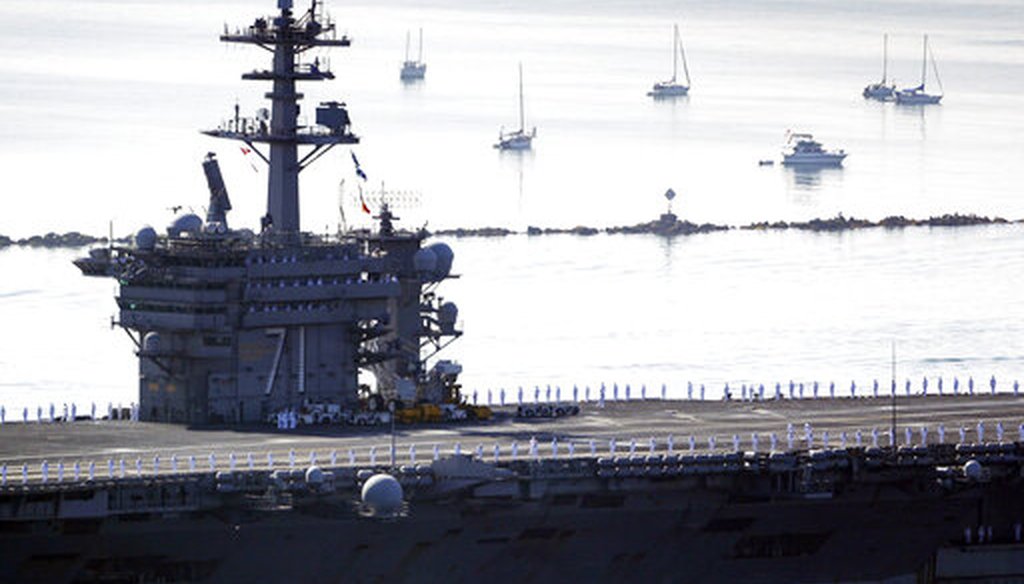 Sailors man the rails as the USS Theodore Roosevelt aircraft carrier makes its way into San Diego Bay on July 9, 2020. The carrier returned to San Diego after a massive COVID-19 outbreak on board. (AP)