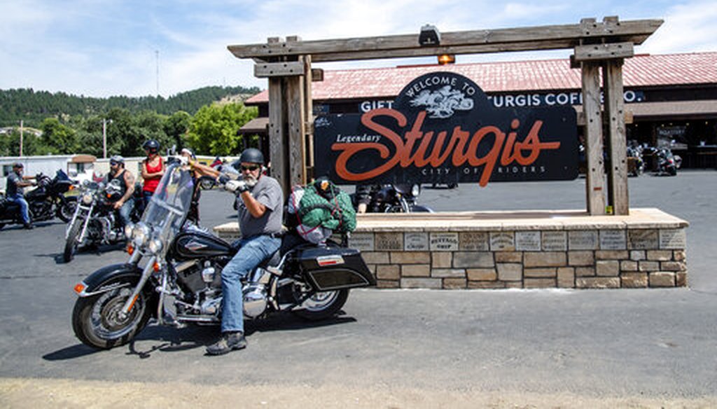 A biker poses in front of the Sturgis welcome sign during the 80th annual Sturgis Motorcycle Rally on Aug. 15, 2020, in Sturgis, S.D. (AP/Harris)