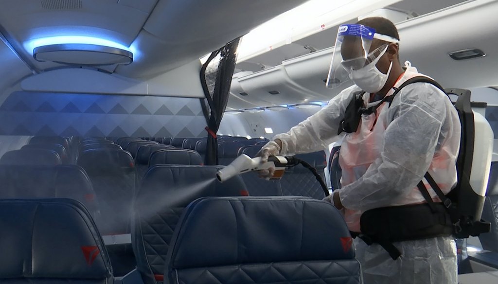 An employee disinfects the inside of a Delta Airplane. (AP)