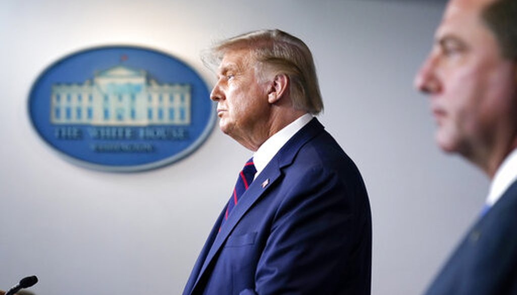 President Donald Trump speaks as Health and Human Services Secretary Alex Azar listens during a media briefing in the James Brady Briefing Room of the White House, Aug. 23, 2020. (AP)
