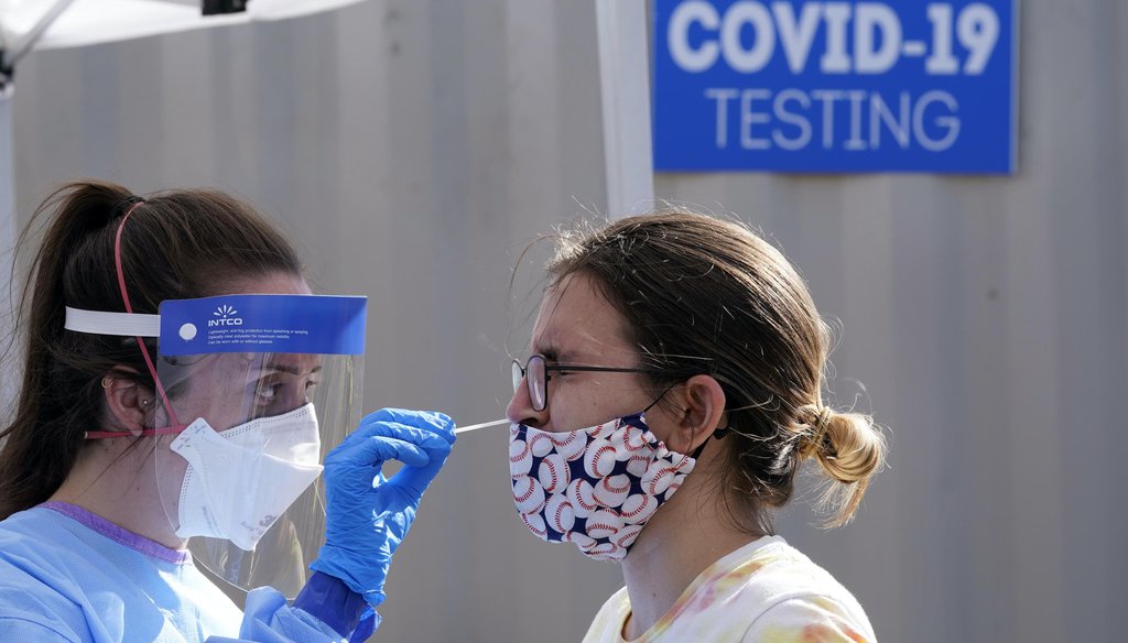Heather Brown, right, is tested for COVID-19 at a new walk-up testing site at Chief Sealth High School on Aug. 28, 2020, in Seattle. (AP)