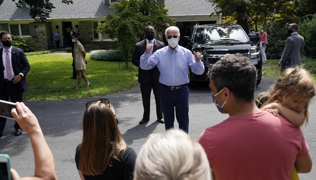 Democratic presidential candidate Joe Biden talks to neighbors gathered outside after he attended an event with local union members in the backyard of a home in Lancaster, Pa., on Sept. 7, 2020. (AP)