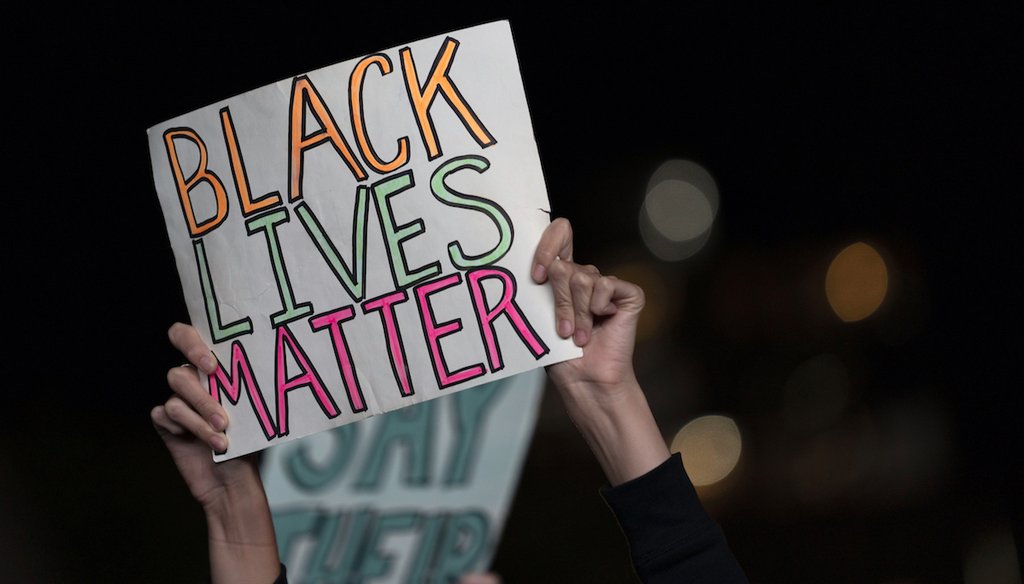 A protester holds up a Black Lives Matter sign as she and others gather in the Brooklyn borough of New York, late Wednesday, Sept. 23, 2020, in New York, following a Kentucky grand jury's decision on the killing of Breonna Taylor. (AP)