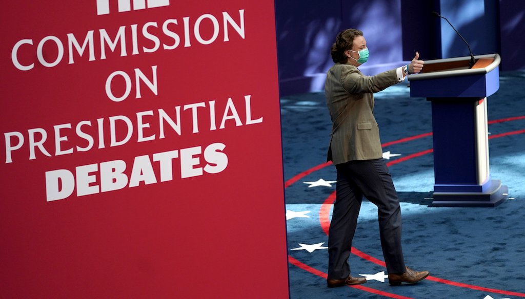 A person gestures while taking the stage during a rehearsal ahead of the first presidential debate. (AP)