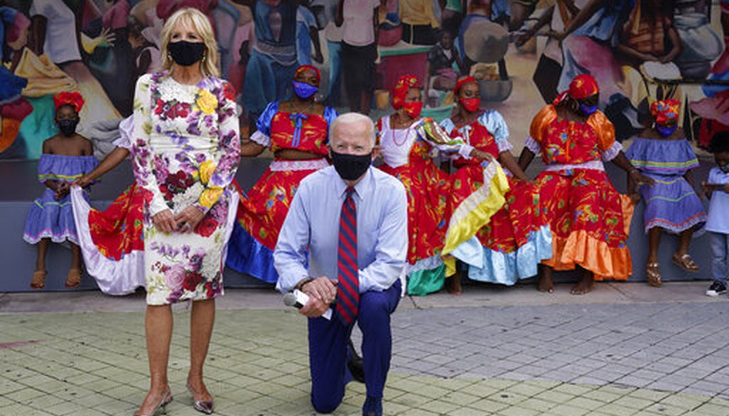 Democratic presidential candidate Joe Biden and his wife, Jill Biden, pose with dancers on a visit to Miami's Little Haiti Cultural Complex, Oct. 5. (AP)