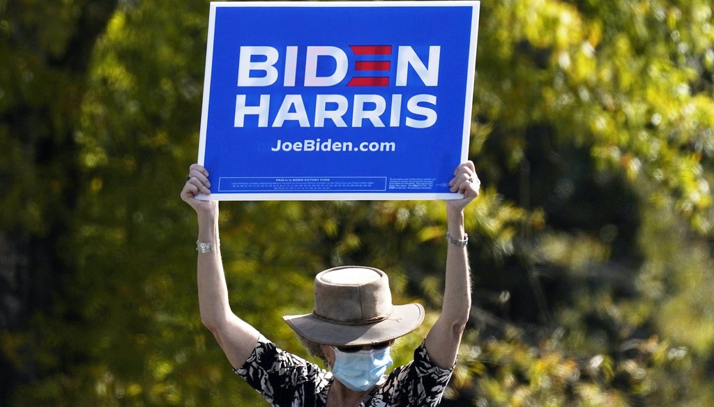 A supporter holds up a sign as Democratic presidential candidate former Vice President Joe Biden speaks during a campaign event at Riverside High School in Durham, N.C., on Oct. 18, 2020. (AP)