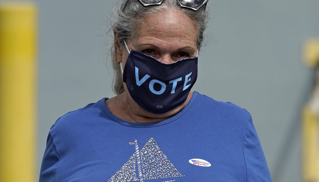 Sylvia Faria, of Lakeland, Fla., wears a "vote" mask as she leaves after early voting at the Polk County Government Center Monday, Oct. 19, 2020, in Lakeland, Fla.  (AP)