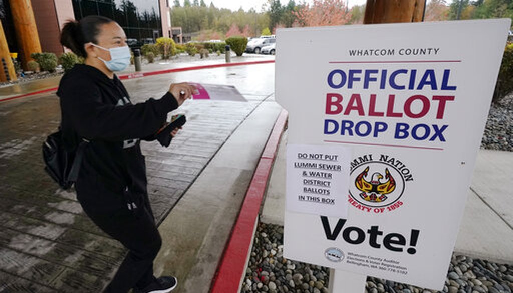 Lummi Tribal member Patsy Wilson casts her ballot into a ballot drop box on Nov. 3, 2020, near Bellingham, Wash. (AP)