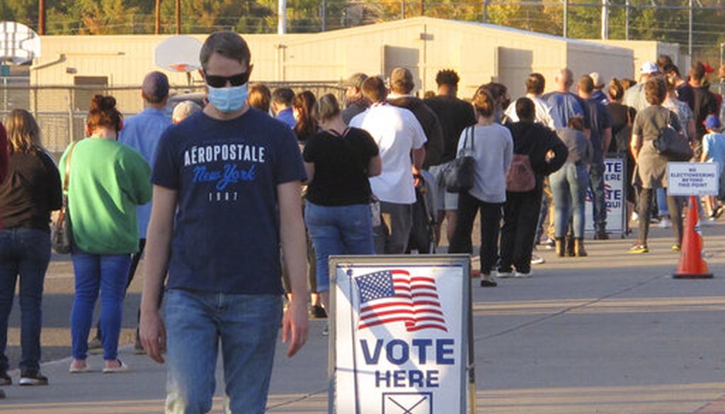 A man leaves the polling place where about 100 mostly masked northern Nevadans were waiting to vote in person in Sparks on Nov. 3, 2020. (AP)