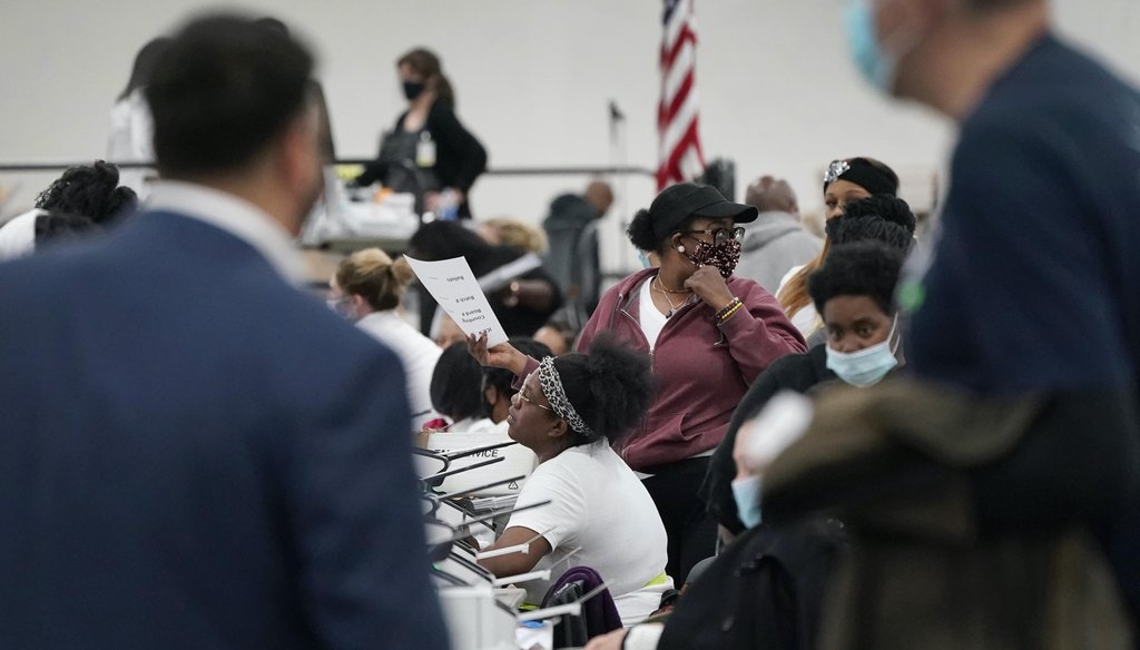 Election challengers observe as ballots are counted at the central counting board on Nov. 4, 2020, in Detroit. (AP)