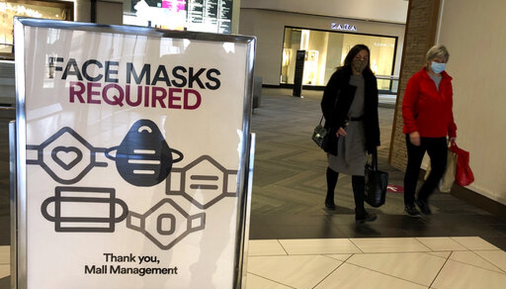In this Nov. 13, 2020 file photo, a "Face masks required" sign is displayed at a shopping center in Schaumburg, Ill. (AP)