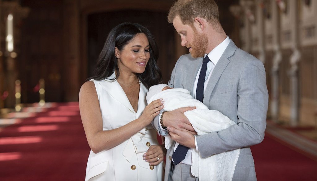Prince Harry and Meghan, Duchess of Sussex, pose with their son Archie in St George's Hall at Windsor Castle in Windsor, south England, on May 8, 2019. (AP/Lipinski)