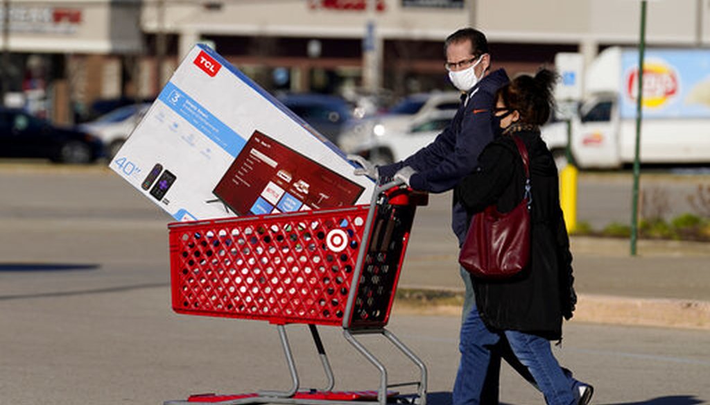 Shoppers leave a Target store after shopping in Niles, Ill., on Nov. 28, 2020. (AP)