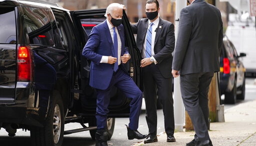 President-elect Joe Biden, wearing a medical boot, leaves his motorcade as he arrives at The Queen theater Dec. 1 in Wilmington, Del. (AP)