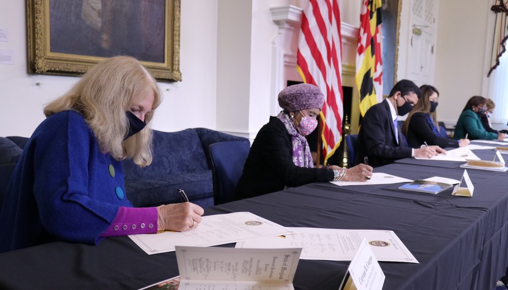 Corynne Courpas, left, signs a certificate during the formal vote of Maryland's 10 electors for Democrat Joe Biden for president and Kamala Harris for vice president. (AP)