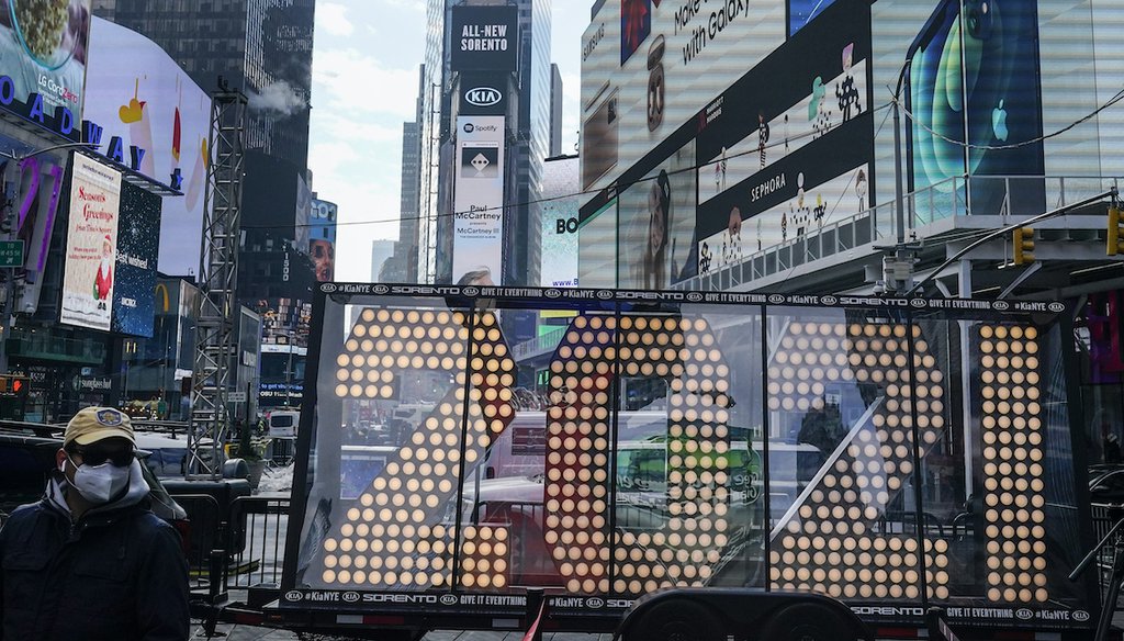 In this Dec. 21, 2020, file photo, a man walks past giant numerals for "2021" to be used in New Year's eve festivities in New York's Times Square. (AP)