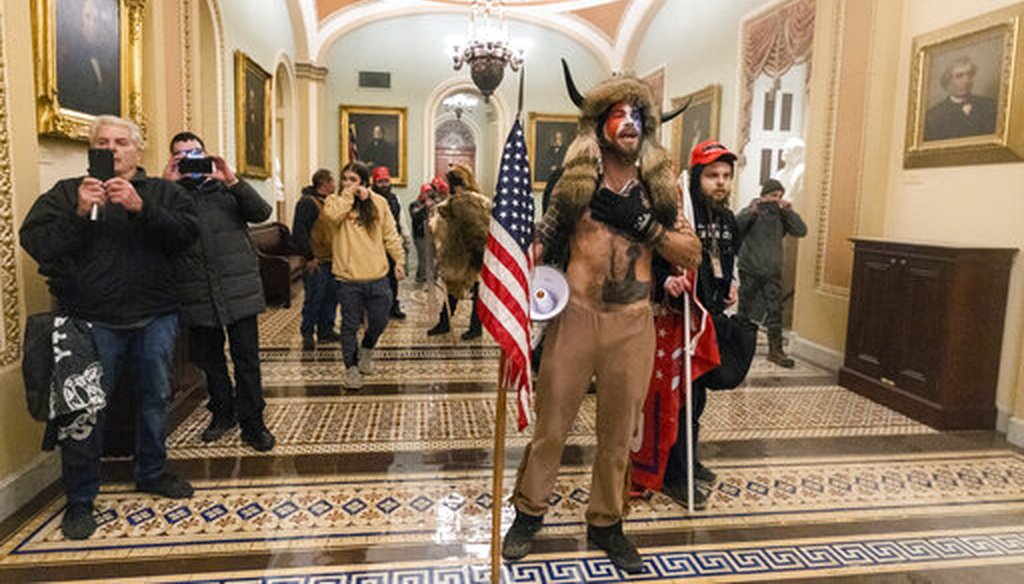 Supporters of President Donald Trump stormed the U.S. Capitol and were photographed outside the Senate Chamber on Jan. 6, 2021 in Washington. (AP/Balce Ceneta)