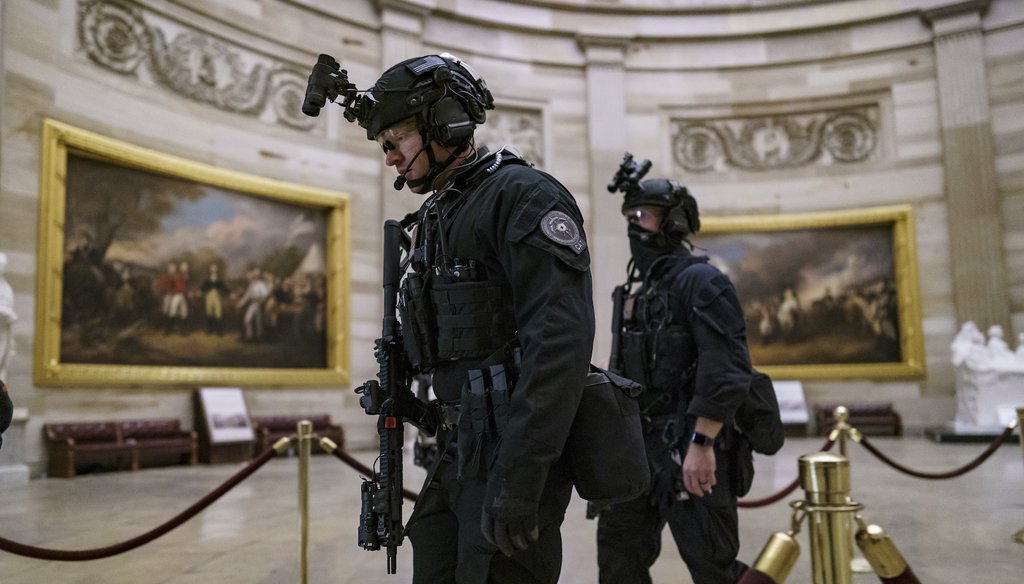 Members of the U.S. Secret Service Counter Assault Team walk through the Rotunda as they and other federal police forces responded as violent protesters loyal to President Donald Trump stormed the U.S. Capitol. (AP Images)