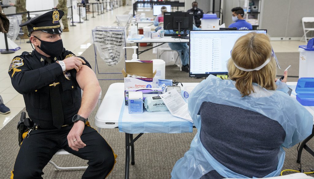 Sergeant Michael Zarro, of the Mount Olive, NJ, Police Department, rolls up his sleeve to receive a COVID-19 vaccination at the Morris County, vaccination site, in Rockaway, NJ, Jan. 8, 2021. (AP)