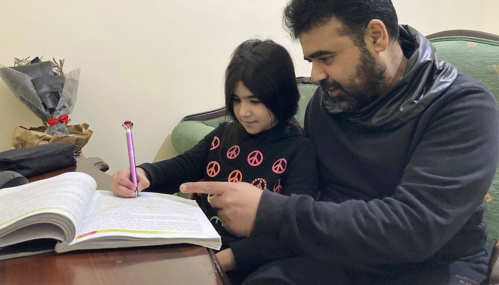 Syrian refugee Mahmoud Mansour, 47, with daughter Sahar, 8, at an apartment in Amman, Jordan, Jan. 20, 2021. Mansour's family had completed paperwork to go to the U.S. before the Trump administration halted the refugee program in 2017. (AP)