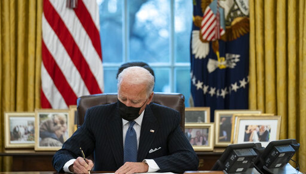 President Joe Biden signs an executive order in the Oval Office on Jan. 25, 2021,. (AP)