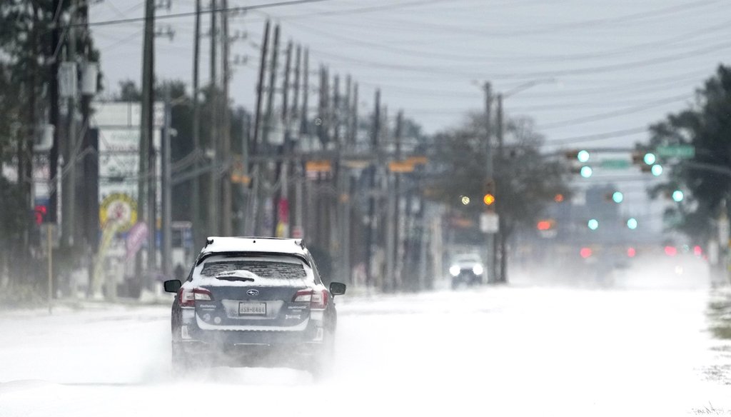 Vehicles drive on snow and sleet covered roads Feb. 15, 2021, in Spring, Texas. (AP)